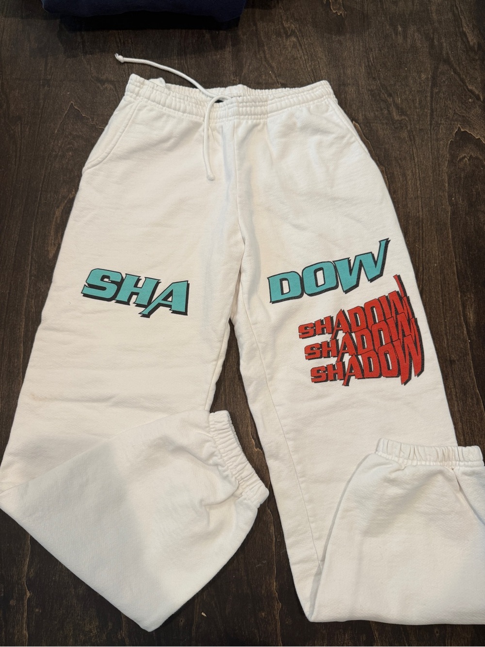 Shadow Hill White Sweatpants with Teal and Red Graphics